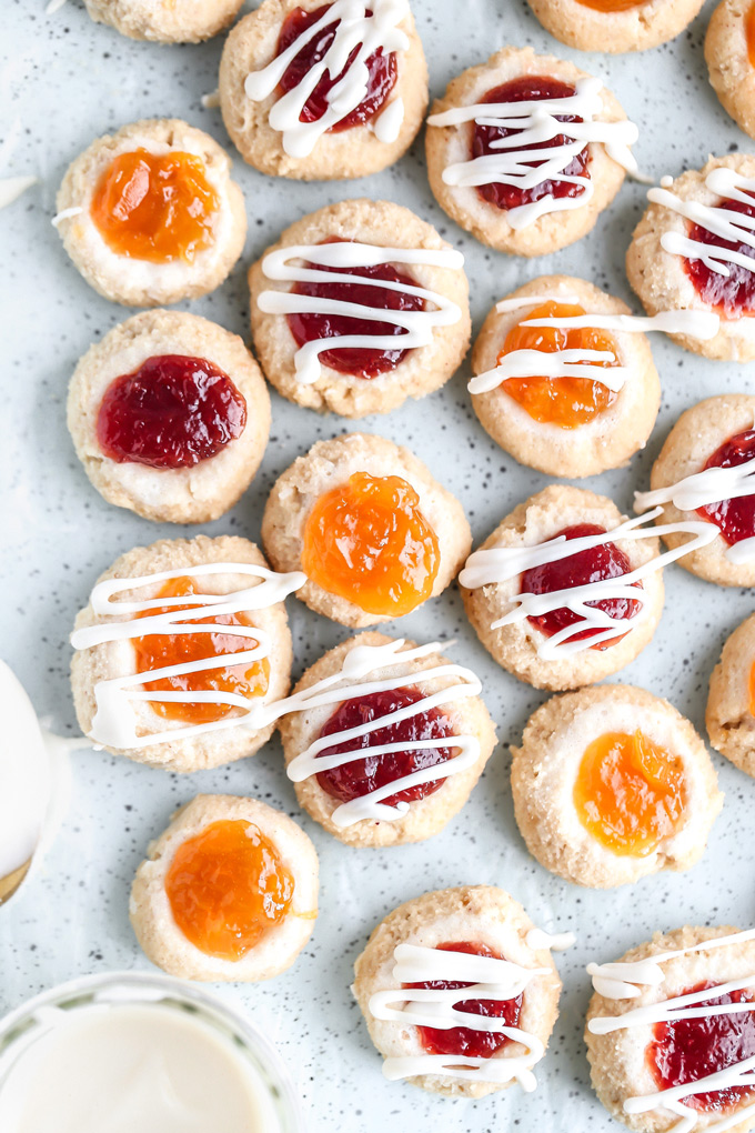 PB&J Thumbprint Cookies - Easy no bake vegan cookies are peanut buttery & filled with jam then topped with a heavenly vanilla glaze. Perfect for any occasion. NeuroticMommy.com #vegan #keto