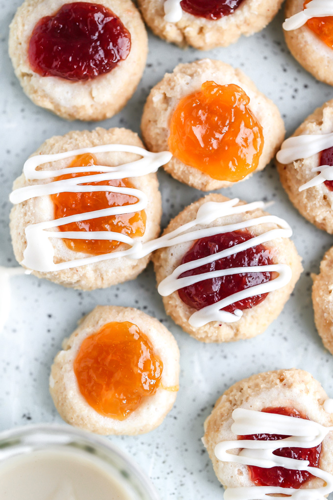 PB&J Thumbprint Cookies - Easy no bake vegan cookies are peanut buttery & filled with jam then topped with a heavenly vanilla glaze. Perfect for any occasion. NeuroticMommy.com #vegan #keto