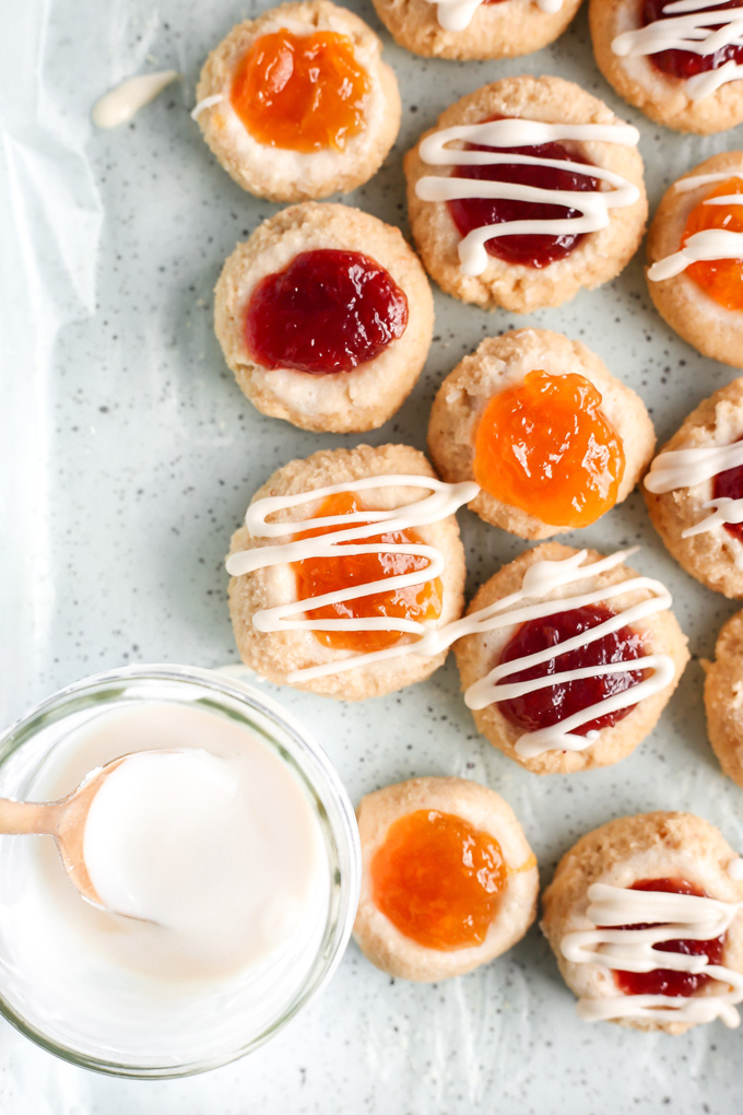 PB&J Thumbprint Cookies - Easy no bake vegan cookies are peanut buttery & filled with jam then topped with a heavenly vanilla glaze. Perfect for any occasion. NeuroticMommy.com #vegan #keto