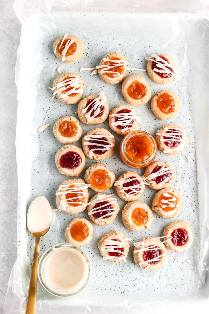 PB&J Thumbprint Cookies - Easy no bake vegan cookies are peanut buttery & filled with jam then topped with a heavenly vanilla glaze. Perfect for any occasion. NeuroticMommy.com #vegan #keto